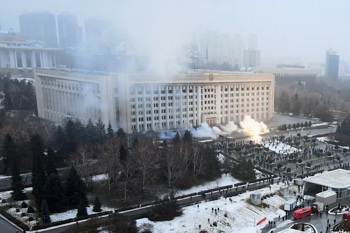 Smoke rises from the city hall building during a protest in Almaty (AP)