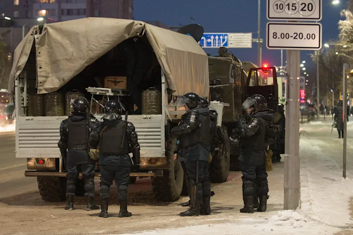 Riot police officers are seen in a street in Nur-Sultan (Turar Kazangapov/TASS)